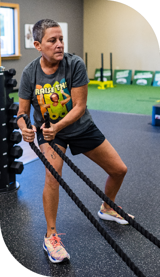 Woman working out with battle ropes